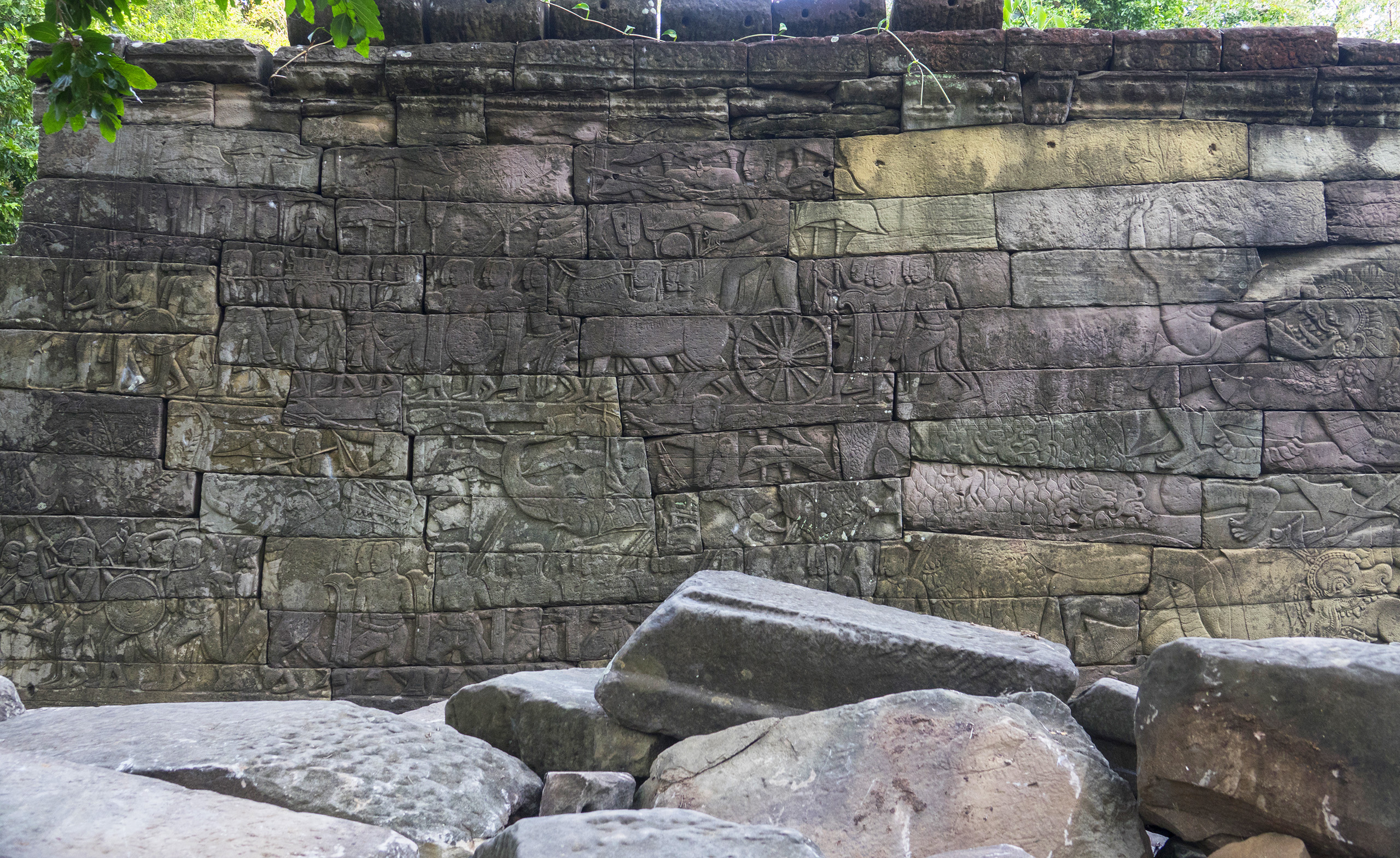 Place page Hero - Banteay Chhmar Ian Stone Stone wall with carvings in the ruins of Banteay Chhmar in Cambodia