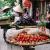 Fresh produce balanced on the back of bicycles