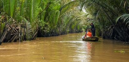 Tourists on boat along the river in the Mekong Delta area in Vietnam