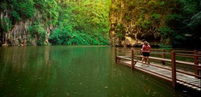 Two tourists admire the tranquil waters of Mirror Lake in Ipoh, Malaysia