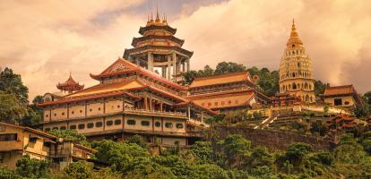 Sunset lights up traditional architecture at Kek Lok Si temple in Penang, Malaysia