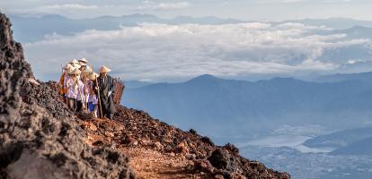 Pilgrims with traditional hats walking on Mount Fuji