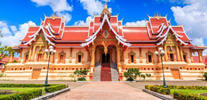 Pha That Luang Stupa looks imposing on a sunny day in Vientiane, Laos