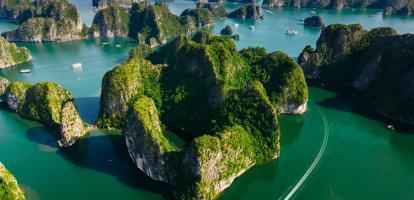 Aerial shot of the fascinating karst rock formations in Lan Ha Bay, with cruise ships in view