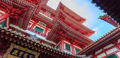 Ornate red temple in middle of Chinatown in Singapore