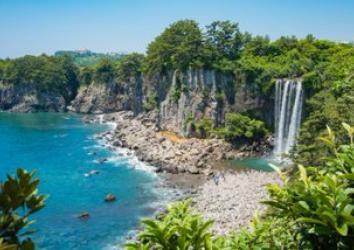 Waterfall by pebble beach in Jeju Island in South Korea