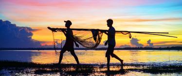Carrying in the fishing nets at sunset