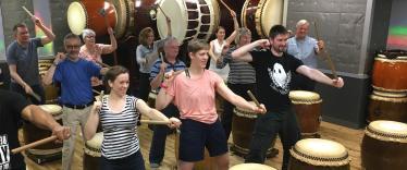 Group learning taiko drumming in Tokyo