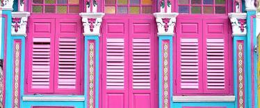 Bright pink doors and colourful trim on Peranakan building in Singapore