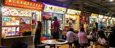 People queuing at food stalls in Singapore Hawker Centre