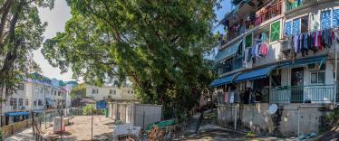 Colourful buildings with washing hanging and bicycle propped up outside