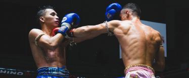 Muay Thai boxers competing in the ring in Bangkok