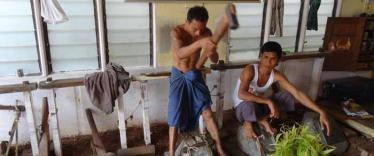 Workers hammering out gold leaf in Mandalay