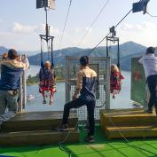 Two people strapped in and about to start the zip line at Nami Island