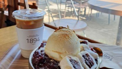 A Korean dessert with ice cream and sweets, with an iced coffee next to it