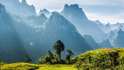 Mountain and blue sky at Kasi, Laos. and little home in grass field in front of mountain