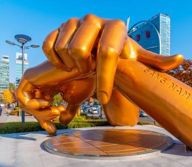 Sculpture of golden hands resting on each other as a Gangnam Style monument in Seoul