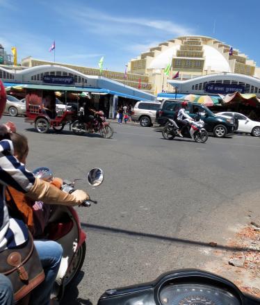 Travelling to Phsar Thmey market on the back of a motorbike