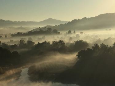 View of early morning mist from hot air balloon