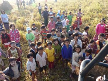 Children waiting for the hot air balloon to land in Burma